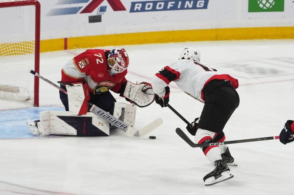 Florida Panthers goaltender Sergei Bobrovsky (72) stops a shot by Ottawa Senators center Shane Pinto (12) during the second period of an NHL hockey game, Saturday, Oct. 11, 2025, in Sunrise, Fla. (AP Photo/Marta Lavandier)
