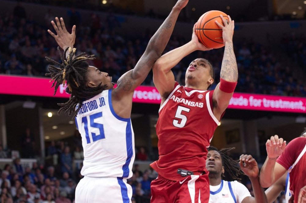 Arkansas guard Darius Acuff Jr. (5) shoots defended by Memphis guard Julius Thedford (15) during the second half of an NCAA college basketball exhibition game Monday, Oct. 27, 2025, in Memphis, Tenn. (AP Photo/Nikki Boertman)