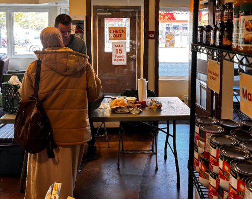 A volunteer with the Hope Mission hands food to a woman amid a provincewide teachers strike in Edmonton in this recent handout photo. THE CANADIAN PRESS/Handout - Hope Mission (Mandatory Credit)