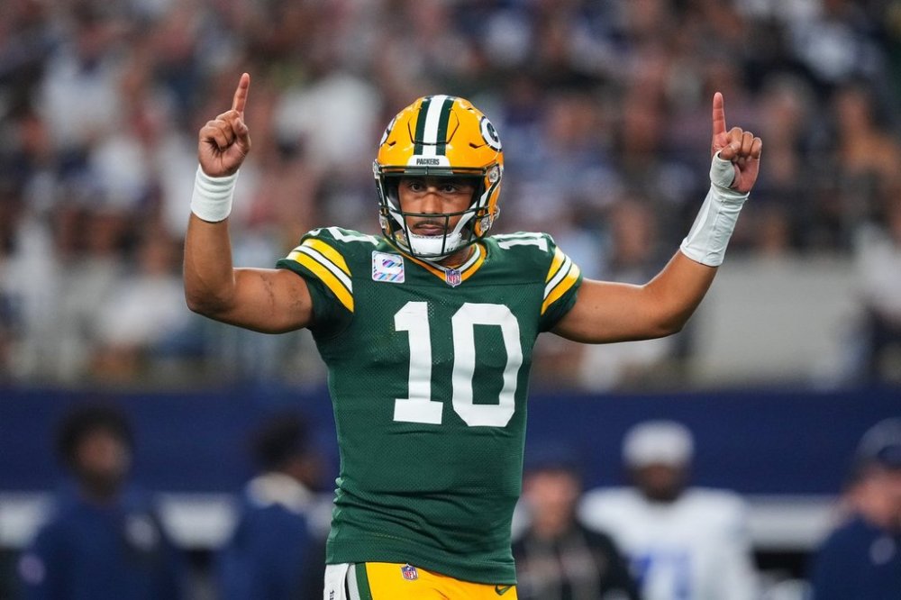 Green Bay Packers' Jordan Love (10) celebrates a touchdown run by Josh Jacobs (8) in the second half of an NFL football game against the Dallas Cowboys Sunday, Sept. 28, 2025, in Arlington, Texas. (AP Photo/Julio Cortez)