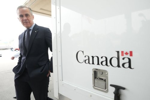 Prime Minister Mark Carney walks by a Canada Border Services Agency vehicle at the Rainbow Bridge border crossing in Niagara Falls, Ont., on Friday, Oct. 17, 2025. THE CANADIAN PRESS/Nathan Denette