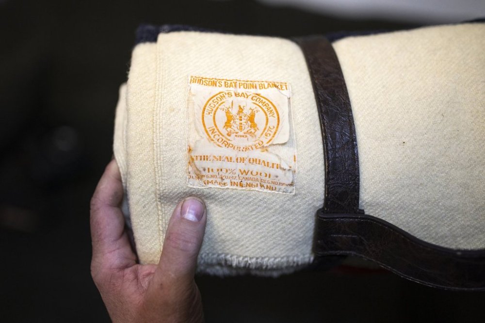 Mark Garner holds a Hudson's Bay Company blanket from the 1950's in his Hamilton, Ont., museum on Thursday, April 17, 2025. THE CANADIAN PRESS/Nick Iwanyshyn
