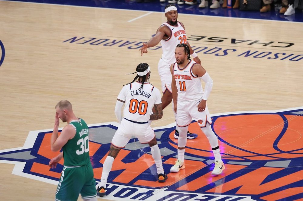 New York Knicks' Jalen Brunson (11) and Guerschon Yabusele (28) celebrate with Jordan Clarkson (00) after his three-point basket while Boston Celtics' Sam Hauser (30) returns to the bench during the first half of an NBA basketball game, Friday, Oct. 24, 2025, in New York. (AP Photo/Heather Khalifa)