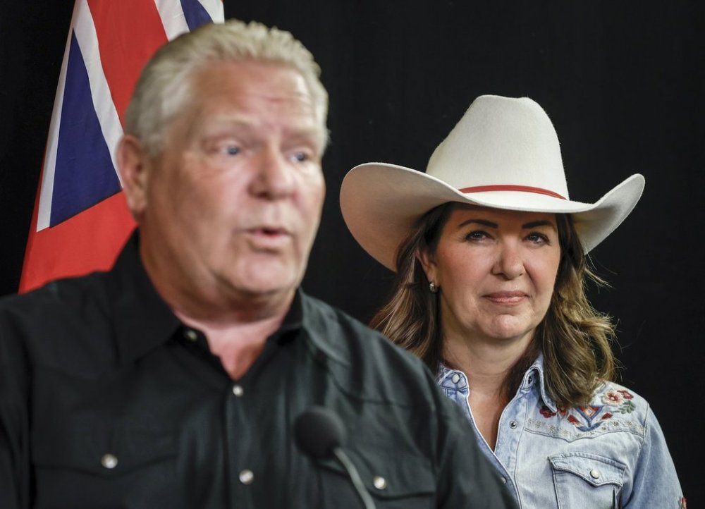Ontario Premier Doug Ford, left, and Danielle Smith, Premier of Alberta, speak before signing agreements to build new energy and trade infrastructure in Calgary, Alta., Monday, July 7, 2025. THE CANADIAN PRESS/Jeff McIntosh