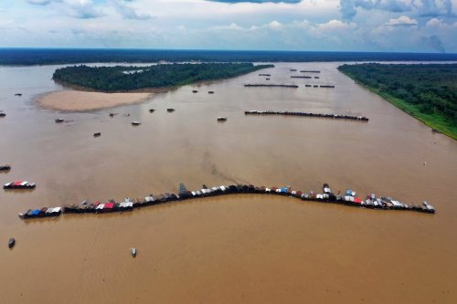 FILE - Dredging barges operated by illegal miners converge on the Madeira River, a tributary of the Amazon river, searching for gold, in Autazes, Amazonas state, Brazil, Nov. 25, 2021. (AP Photo/Edmar Barros, File)