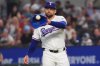 FILE - Texas Rangers starting pitcher Nathan Eovaldi reaches for the ball during the first inning of a baseball game against the New York Yankees, Tuesday, Aug. 5, 2025, in Arlington, Texas. (AP Photo/LM Otero, File)