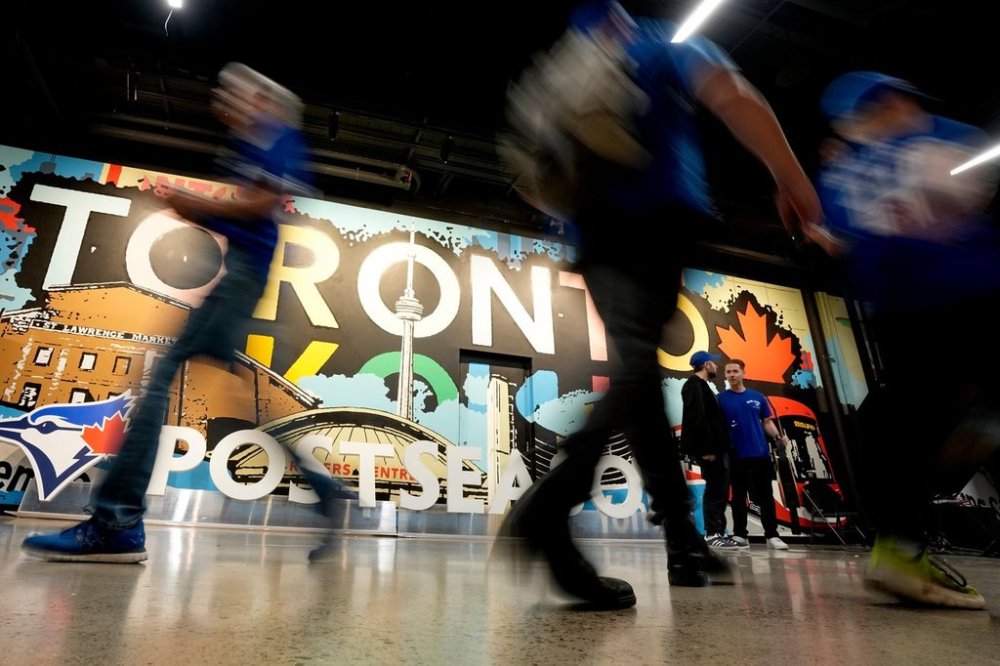 Fans arrive prior to Game 6 of baseball's American League Championship Series between the Toronto Blue Jays and the Seattle Mariners, Sunday, Oct. 19, 2025, in Toronto. (AP Photo/David J. Phillip)