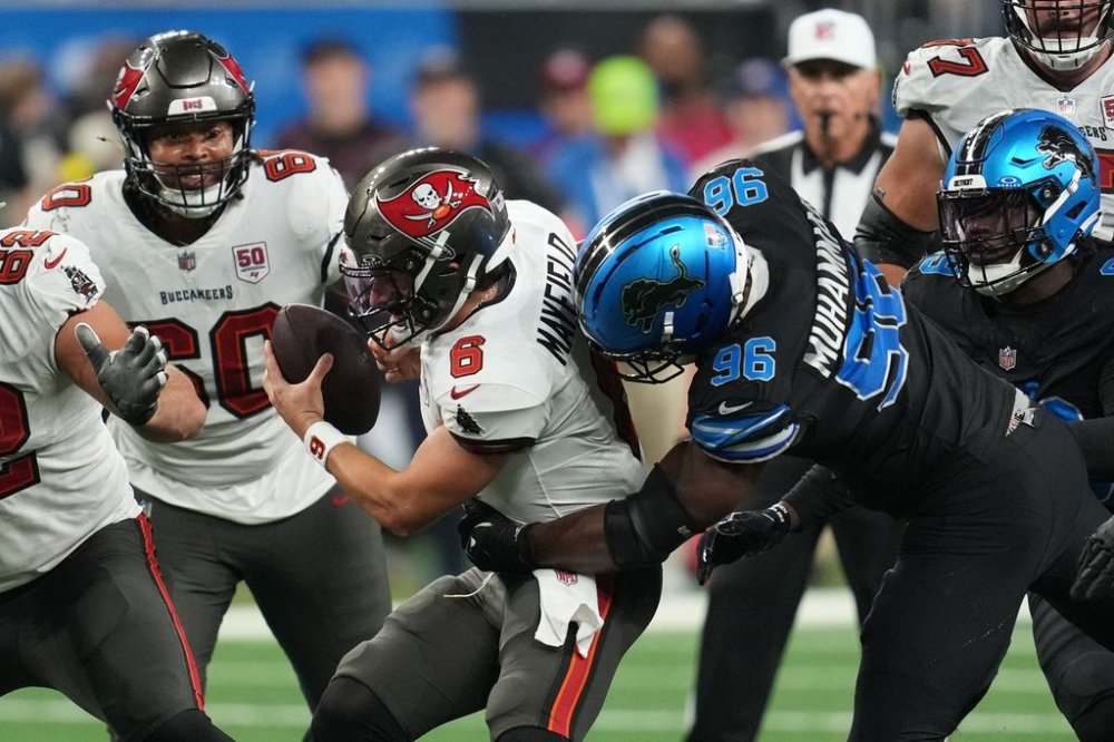 Detroit Lions defensive end Al-Quadin Muhammad (96) hits Tampa Bay Buccaneers quarterback Baker Mayfield (6) causing him to fumble during the second half of an NFL football game, Monday, Oct. 20, 2025, in Detroit. AP Photo/Paul Sancya)