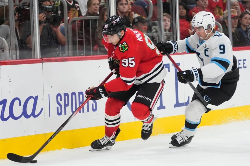 Chicago Blackhawks right wing Ilya Mikheyev, left, and Utah Mammoth right wing Clayton Keller (9) chase the puck during the second period of an NHL hockey game Monday, Oct. 13, 2025, in Chicago. (AP Photo/Erin Hooley)