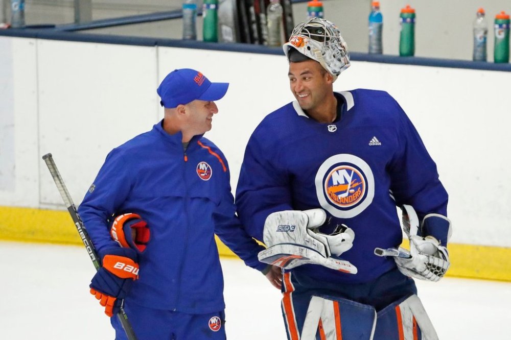 FILE - New York Islanders goalie Chris Gibson, right, of Finland, talks to a coach Piero Greco during a break in an NHL hockey team practice, Monday, July 13, 2020, in East Meadow, N.Y. (AP Photo/Kathy Willens, File)