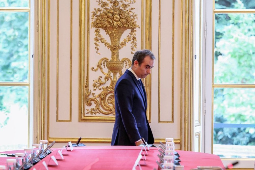 France's reappointed Prime Minister Sebastien Lecornu walks past a meeting table as he welcomes the newly-appointed members of his cabinet in Paris, Monday, Oct. 13, 2025. (Alain Jocard, Pool photo via AP)