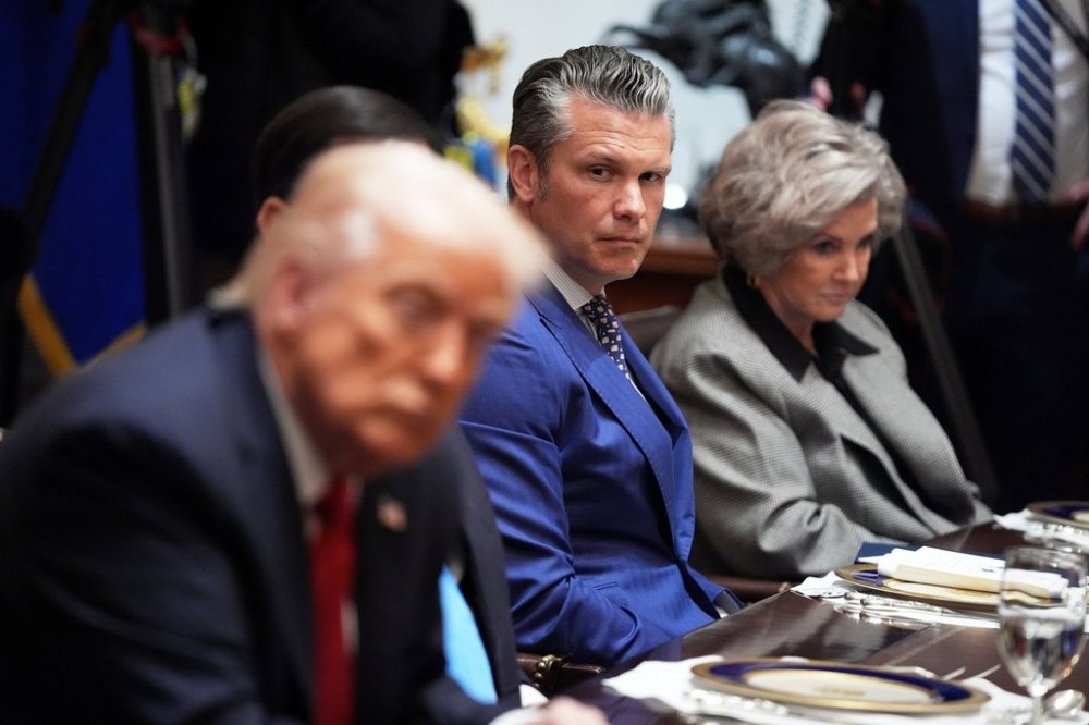Defense Secretary Pete Hegseth listens as he and White House Chief of Staff Susie Wiles, right, listen during a meeting with President Donald Trump, in foreground left, and Australian Prime Minister Anthony Albanese in the Cabinet Room of the White House, Monday, October 20, 2025, in Washington. (AP Photo/Evan Vucci)