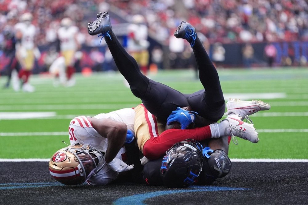 Houston Texans cornerback Kamari Lassiter, right, intercepts a pass intended for San Francisco 49ers wide receiver Jauan Jennings (15) during the second half of an NFL football game Sunday, Oct. 26, 2025, in Houston. (AP Photo/Eric Gay)