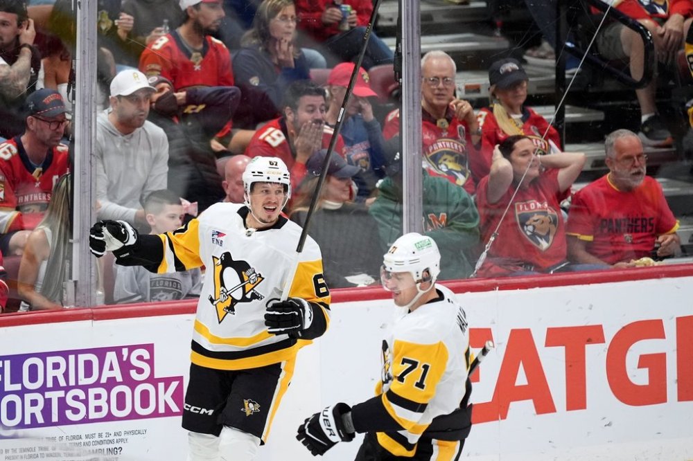 Florida Panthers fans react in the stands as Pittsburgh Penguins right wing Rickard Rakell (67) celebrates after scoring his team's second goal, during the second period of an NHL hockey game, Thursday, Oct. 23, 2025, in Sunrise, Fla. (AP Photo/Rebecca Blackwell)