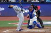 Los Angeles Dodgers' Shohei Ohtani leans away from an inside pitch as Toronto Blue Jays' Alejandro Kirk makes the catch during the seventh inning in Game 1 of baseball's World Series, Friday, Oct. 24, 2025, in Toronto. (AP Photo/David J. Phillip)