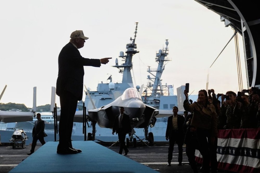 President Donald Trump gestures as he walks towards the stage before speaking to members of the military aboard the USS George Washington, an aircraft carrier docked at an American naval base, in Yokosuka, Tuesday, Oct. 28, 2025. (AP Photo/Mark Schiefelbein)