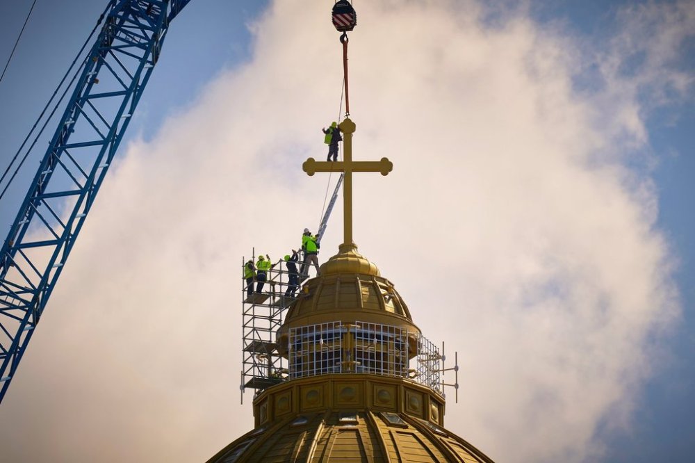 FILE - A construction worker gives a thumbs up in the final stages of installation for the main cross of the National Cathedral, in Bucharest, Romania, Tuesday, April 8, 2025. (AP Photo/Vadim Ghirda, File)