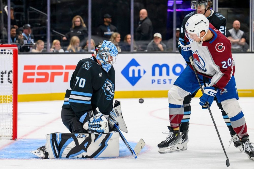 Utah Mammoth goaltender Karel Vejmelka (70) makes the save on the deflected puck by Colorado Avalanche center Ross Colton (20) during the third period of an NHL hockey game Tuesday, Oct. 21, 2025, in Salt Lake City, Utah. (AP Photo/Tyler Tate)