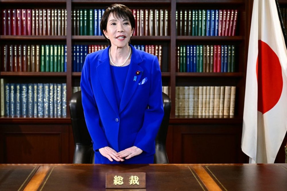 FILE - Sanae Takaichi, the newly-elected leader of Japan's ruling party, the Liberal Democratic Party (LDP), gestures as she leaves the party leader's office after the LDP leadership election in Tokyo, on Oct. 4, 2025. (Yuichi Yamazaki/Pool Photo via AP, File)