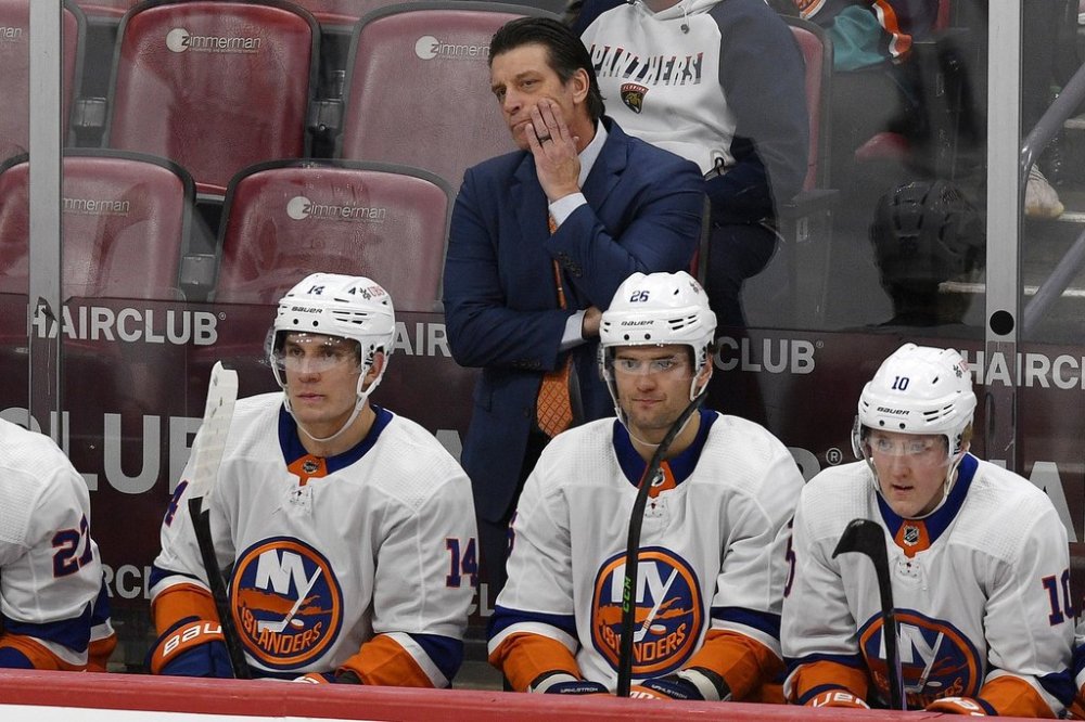 New York Islanders head coach Lane Lambert watches from behind the bench during a game against the Florida Panthers on Saturday, Dec. 2, 2023, in Sunrise, Fla. (AP Photo/Michael Laughlin)