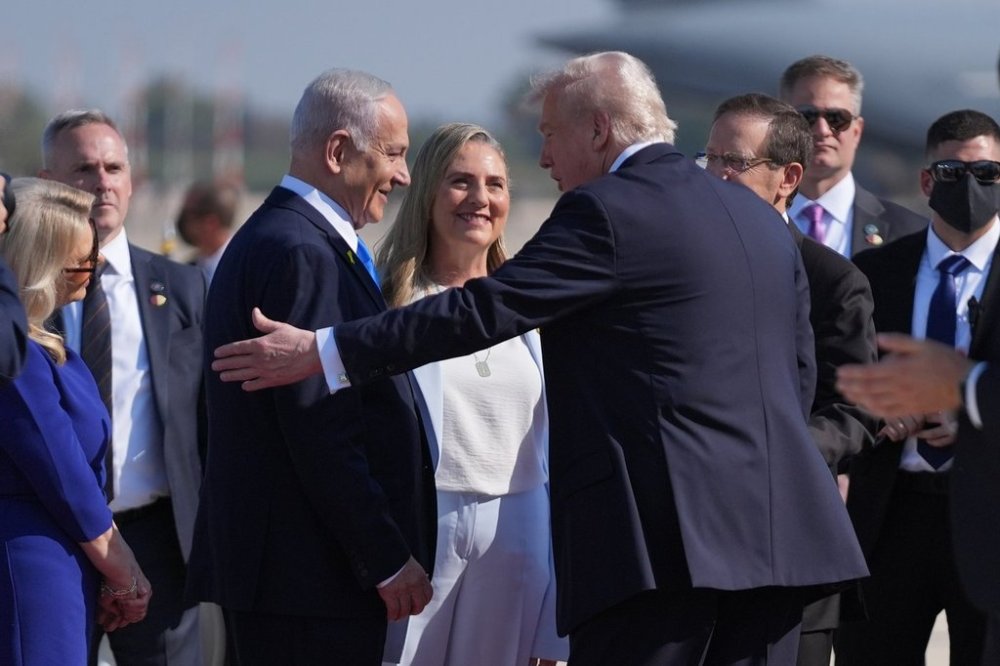 President Donald Trump greets Israel's Prime Minister Benjamin Netanyahu as he arrives at Ben Gurion International Airport, Monday, Oct. 13, 2025, near Tel Aviv. (AP Photo/Evan Vucci)
