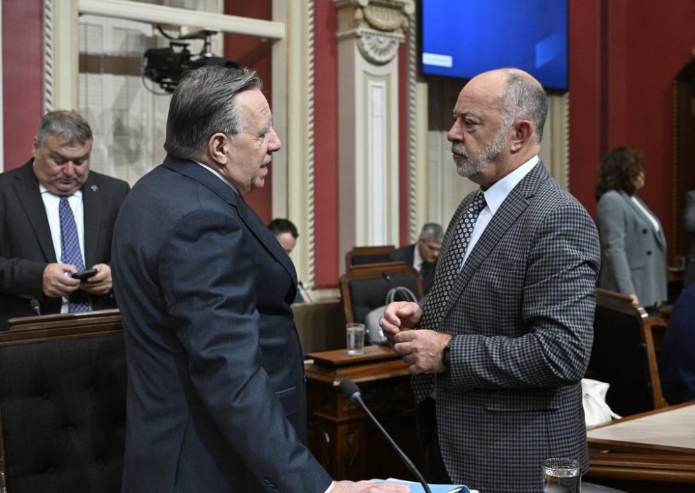 Quebec Premier Francois Legault, left, speaks with Quebec Health Minister Christian Dube before question period at the legislature in Quebec City, Thursday, Oct. 23, 2025 THE CANADIAN PRESS/Jacques Boissinot