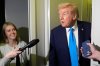 President Donald Trump speaks with reporters as White House press secretary Karoline Leavitt listens aboard Air Force One at Al Udeid Air Base in Doha, Qatar, Saturday, Oct. 25, 2025. (AP Photo/Mark Schiefelbein)