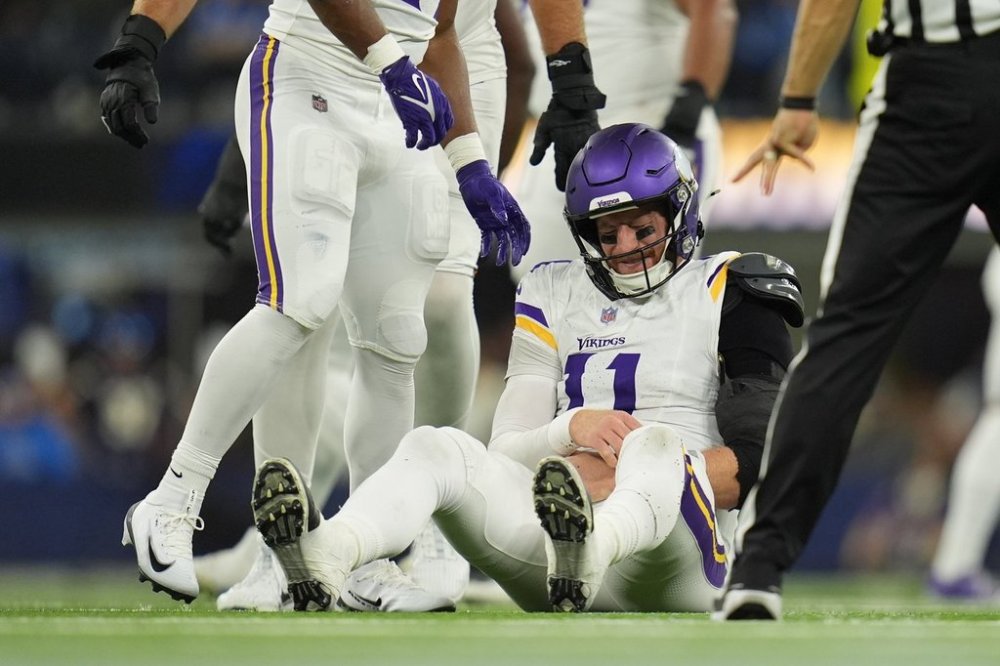 Minnesota Vikings quarterback Carson Wentz (11) sits on the ground after a hit during the second half of an NFL football game against the Los Angeles Chargers Thursday, Oct. 23, 2025, in Inglewood, Calif. (AP Photo/Gregory Bull)