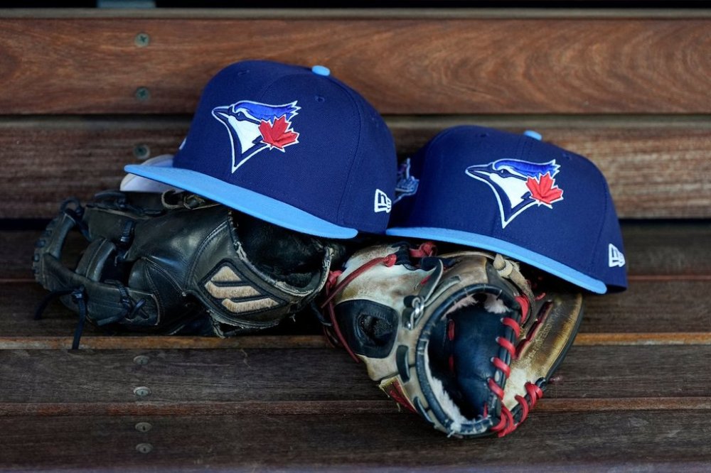 A pair of Toronto Blue Jays hats and gloves sit on the dugout bench prior to Game 5 of baseball's World Series against the Los Angeles Dodgers, Wednesday, Oct. 29, 2025, in Los Angeles. (AP Photo/Ashley Landis)