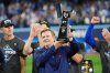 Edward S. Rogers III, chairman of the board of directors of Rogers Communications, holds the American League Championship Series trophy as the Blue Jays celebrate after defeating the Seattle Mariners in MLB American League Championship Series game 7 baseball action in Toronto, Monday, Oct. 20, 2025. THE CANADIAN PRESS/Frank Gunn