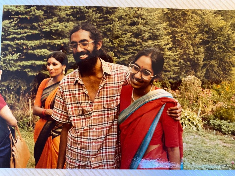 Tejaswini Rao chats with party guests while Subramanyam and Saraswathi Vedam embrace during their parents' wedding anniversary party at State College, Pa., in August 1981. (Saraswathi Vedam via AP)
