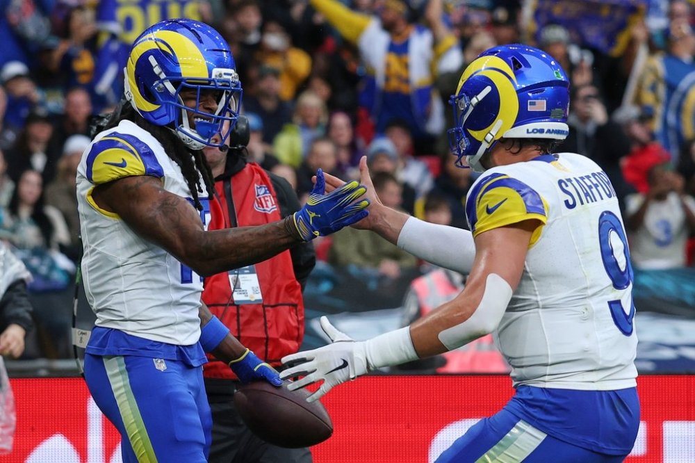 Los Angeles Rams wide receiver Davante Adams (17) celebrates with Los Angeles Rams quarterback Matthew Stafford (9) after scoring a touchdown during the first half of an NFL football game between the Los Angeles Rams and the Jacksonville Jaguars in London, Sunday, Oct. 19, 2025. (AP Photo/Ian Walton)