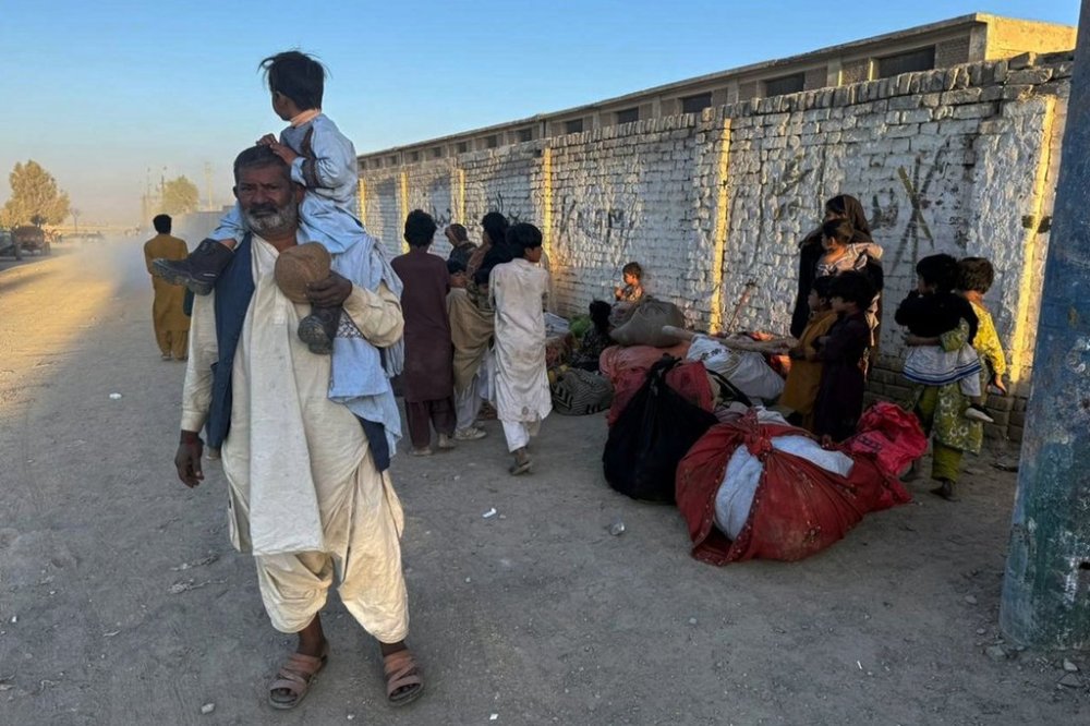 Local residents, who fled their homes following border clashes between Pakistan and Afghan forces, wait for transportation in Chaman, a town on the Pakistan side of the Afghanistan border, Wednesday, Oct. 15, 2025. (AP Photo/H. Achakzai)