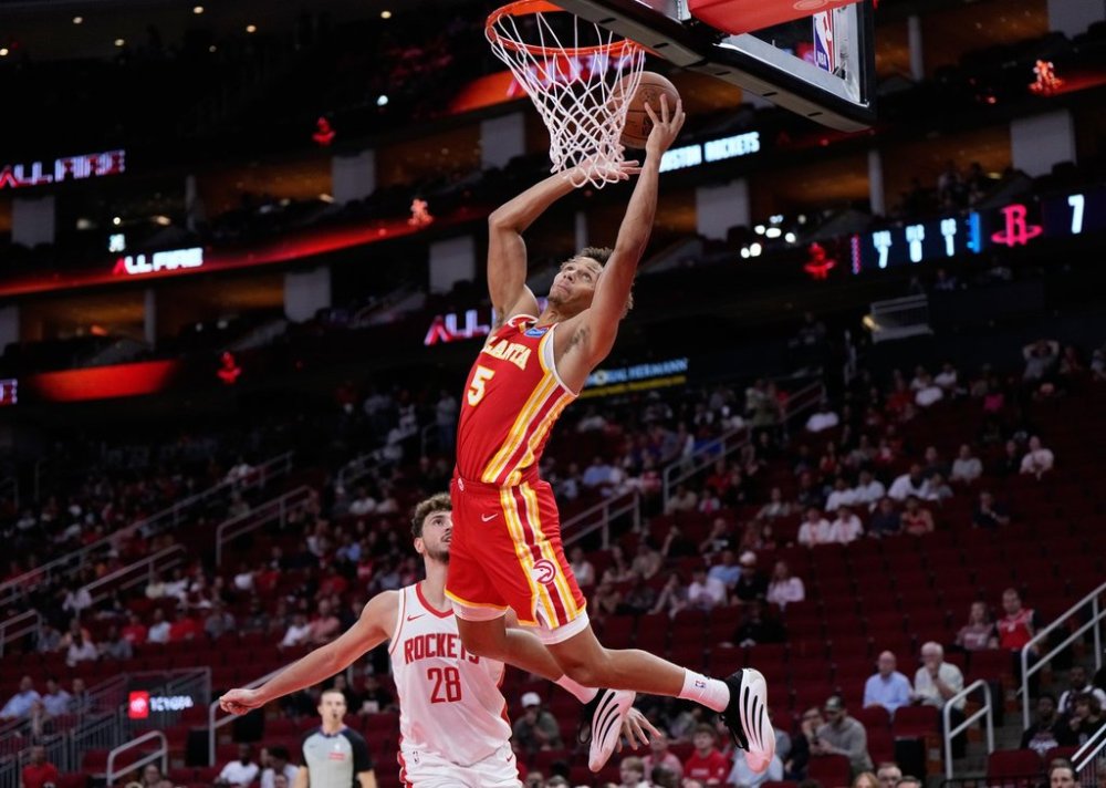 Atlanta Hawks guard Dyson Daniels (5) shoots against Houston Rockets center Alperen Sengun (28) during the first half of an NBA basketball preseason game in Houston, Monday, Oct. 6, 2025. (AP Photo/Ashley Landis)