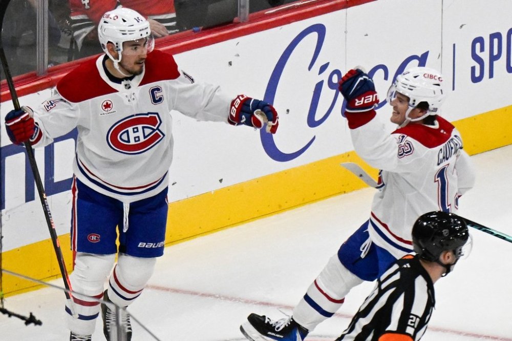 Montreal Canadiens right wing Cole Caufield (13) celebrates with centre Nick Suzuki, left, after Caufield scores a goal against the Chicago Blackhawks during the second period of an NHL hockey game Saturday, Oct. 11, 2025, in Chicago. (AP Photo/Matt Marton)