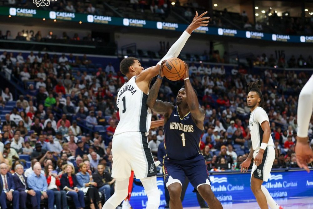New Orleans Pelicans forward Zion Williamson (1) tries to make a move against San Antonio Spurs forward Victor Wembanyama (1) during the first half of an NBA basketball game Friday, Oct. 24, 2025, in New Orleans. (AP Photo/Peter Forest)