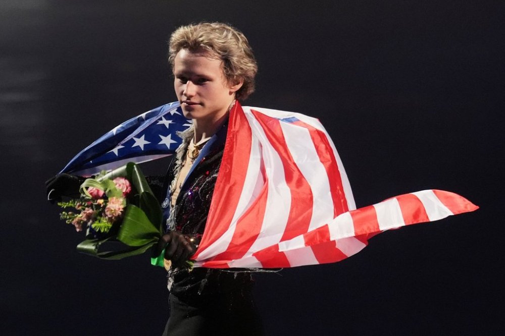 FILE - Gold medalist Ilia Malinin, of the United States, celebrates during a medal ceremony for men's free skating at the figure skating world championships, March 29, 2025, in Boston. (AP Photo/Charles Krupa, File)