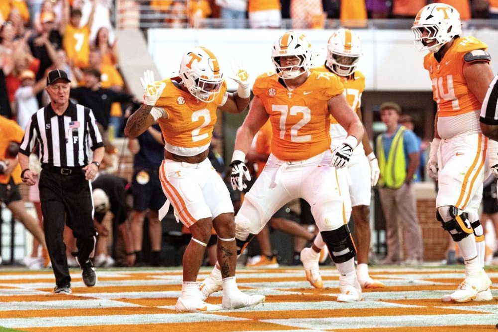 Tennessee running back Peyton Lewis (2) celebrates with offensive lineman Shamurad Umarov (74) and Jesse Perry after scoring a touchdown during the second half of an NCAA college football game against Arkansas, Saturday, Oct. 11, 2025, in Knoxville, Tenn. (AP Photo/Wade Payne)