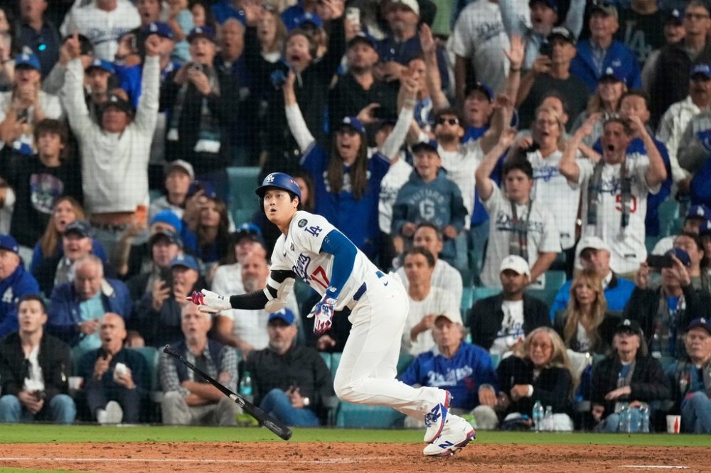 Los Angeles Dodgers' Shohei Ohtani watches his RBI-Double against the Toronto Blue Jays during the fifth inning in Game 3 of baseball's World Series, Monday, Oct. 27, 2025, in Los Angeles.(AP Photo/Mark J. Terrill)