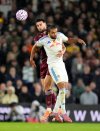 West Ham United's Max Kilman, rear, and Leeds United's Dominic Calvert-Lewin in action during the English Premier League soccer match between Leeds United and West Ham United at Elland Road, Leeds, England, Friday Oct. 24, 2025. (Danny Lawson/PA via AP)