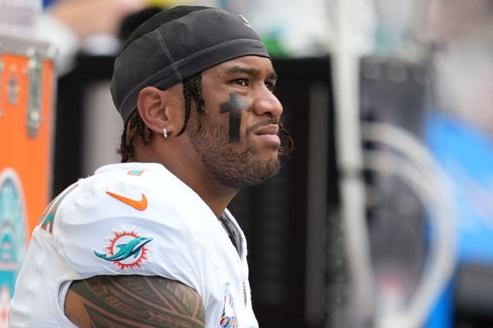 Miami Dolphins quarterback Tua Tagovailoa looks on from the sidelines during the first half of an NFL football game against the Los Angeles Chargers Sunday, Oct. 12, 2025, in Miami Gardens, Fla. (AP Photo/Rebecca Blackwell)