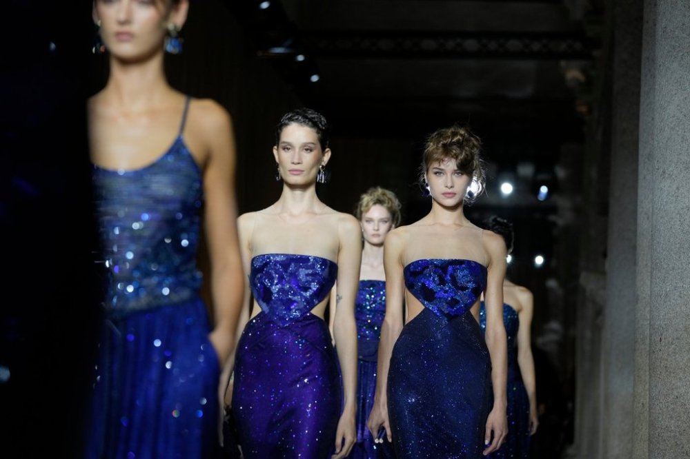 Models wear creations as part of the Giorgio Armani Spring/Summer 2026 collection show in Milan, Italy, Sunday, Sept. 28, 2025. (AP Photo/Luca Bruno)