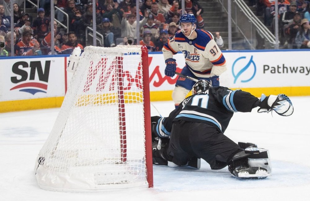 Utah Mammoth's goalie Karel Vejmelka (70) is scored on by Edmonton Oilers' Connor McDavid (97) during second period NHL action, in Edmonton on Tuesday, Oct. 28, 2025. THE CANADIAN PRESS/Jason Franson