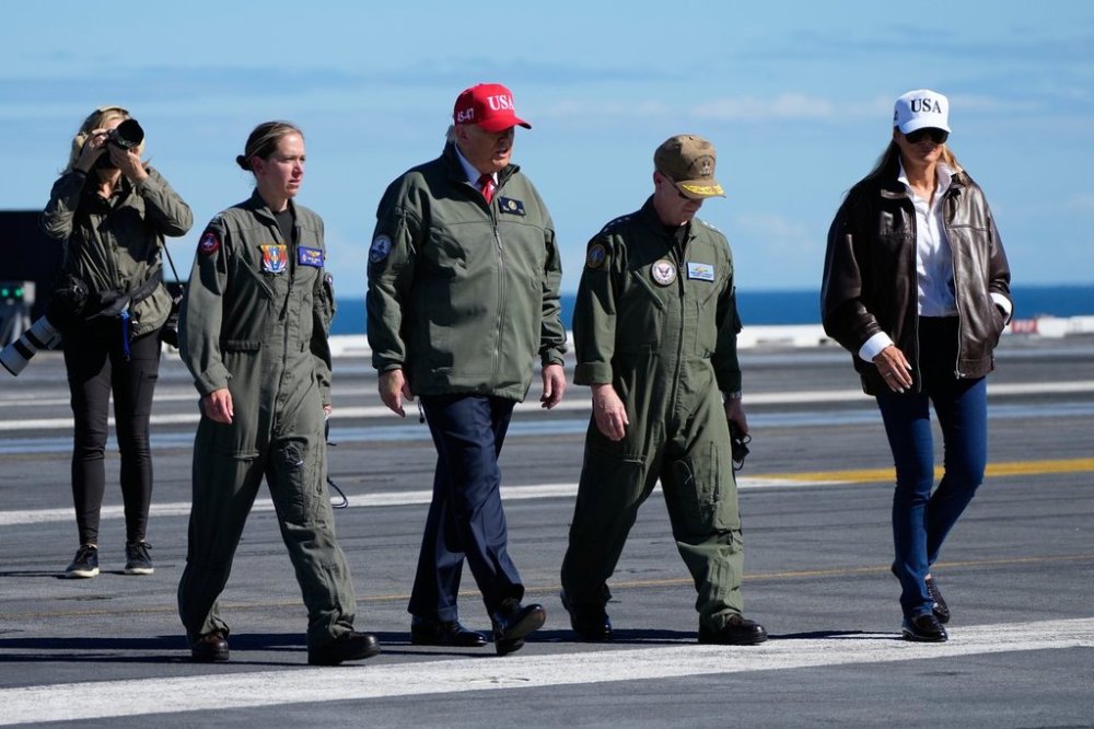 President Donald Trump and first lady Melania Trump walk on the flight deck as part of the Navy's 250th anniversary celebration, aboard the USS George H.W. Bush aircraft carrier in the Atlantic Ocean off the coast of Norfolk, Va., Sunday, Oct. 5, 2025. (AP Photo/Alex Brandon)