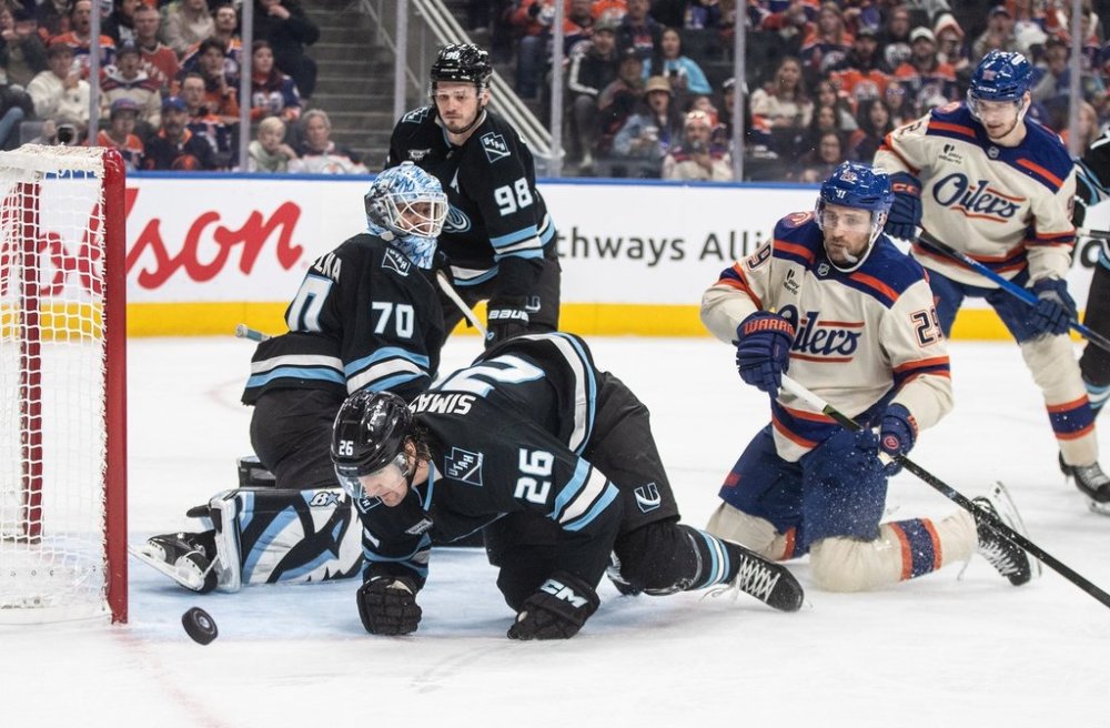 Utah Mammoth goalie Karel Vejmelka (70) makes the save as Dmitriy Simashev (26) and Edmonton Oilers' Leon Draisaitl (29) scramble for the rebound during second period NHL action, in Edmonton on Tuesday, October 28, 2025. THE CANADIAN PRESS/Jason Franson