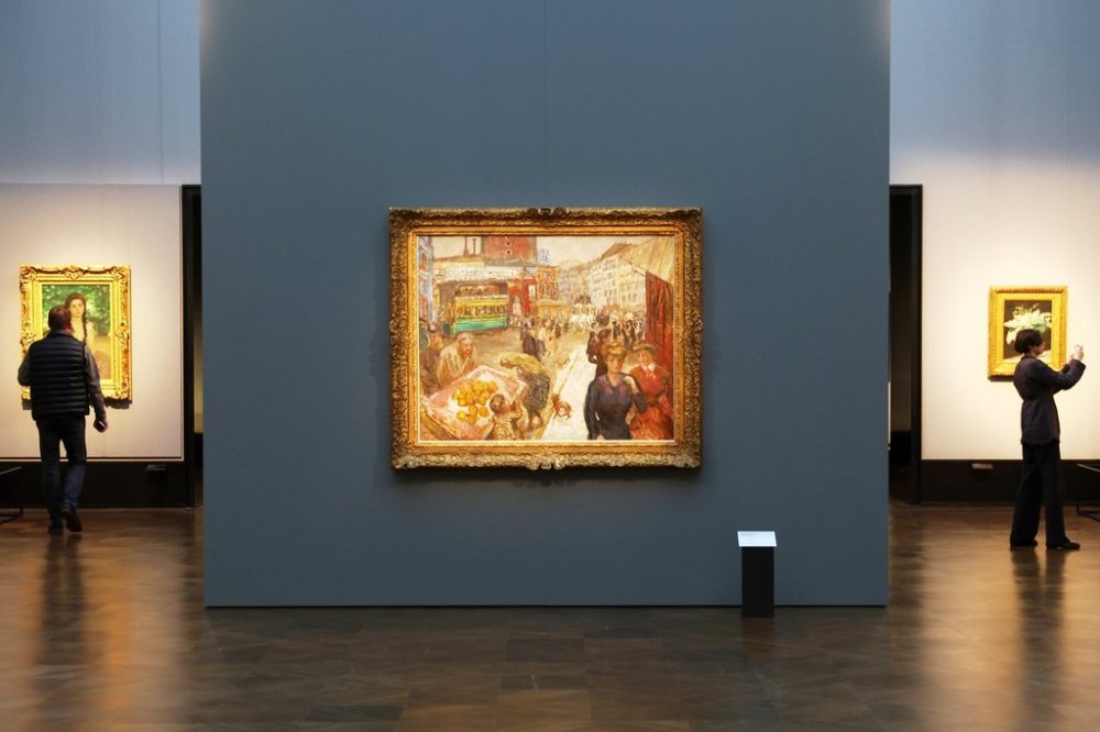 Journalists walks next to the painting
