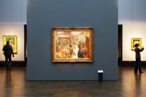 Journalists walks next to the painting 