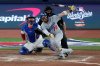 Los Angeles Dodgers' Miguel Rojas follows through on a home run against the Toronto Blue Jays during the ninth inning in Game 7 of baseball's World Series, Saturday, Nov. 1, 2025, in Toronto. (AP Photo/Ashley Landis)