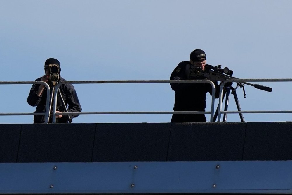 Snipers patrol on the roof of the Fruili Hotel where the Israeli national team is staying, ahead of a World Cup 2026, Group I qualifying soccer match between Italy and Israel at the Friuli Stadium in Udine, Italy, Tuesday, Oct.14, 2025. (AP Photo/Luca Bruno)