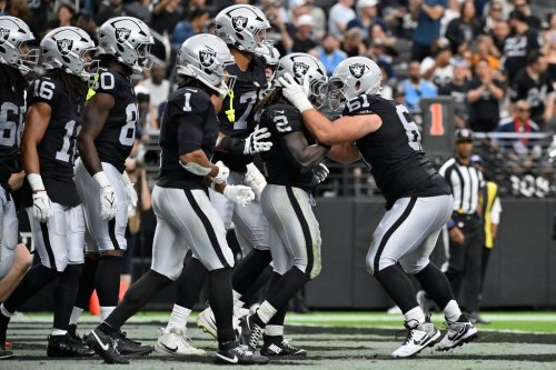 Las Vegas Raiders guard Jordan Meredith (61) celebrates after Las Vegas Raiders running back Ashton Jeanty (2) scored a touchdown against the Tennessee Titans during the second half of an NFL football game, Sunday, Oct. 12, 2025, in Las Vegas. (AP Photo/David Becker)